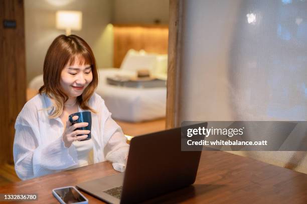 businesswoman in casual clothes working on laptop at night - bad bangs stock pictures, royalty-free photos & images