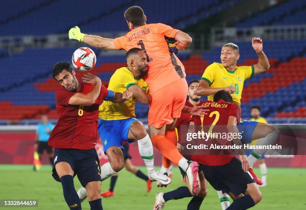 Matheus Cunha of Team Brazil is fouled by Unai Simon of Team Spain leading to a penalty being awarded during the Men's Gold Medal Match between...