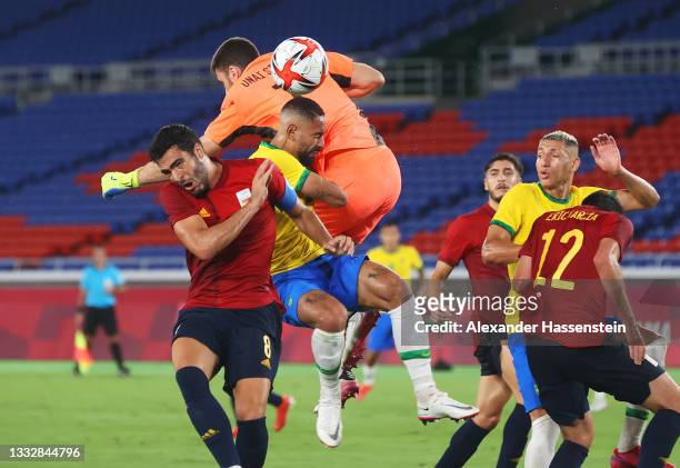 Matheus Cunha of Team Brazil is fouled by Unai Simon of Team Spain leading to a penalty being awarded during the Men's Gold Medal Match between...