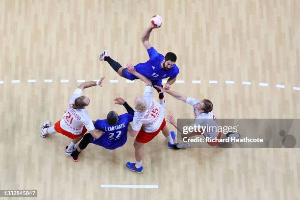 Nikola Karabatic of Team France shoots for goal as Henrik Moellgaard, Magnus Saugstrup and Mathias Gidsel of Team Denmark defend during the Men's...