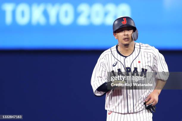 Infielder Hideto Asamura of Team Japan returns to dugout after sending Infielder Sosuke Genda as a pinch runner in the seventh inning during the gold...
