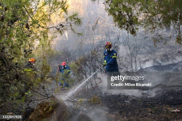 Firefighter battles wild fire in Thrakomacedones area, in northern Athens, on August 7, 2021 in Athens, Greece. People were evacuated from their...