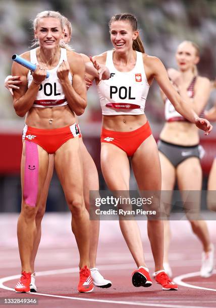 Justyna Swiety-Ersetic of Team Poland celebrates with teammates after winning the silver medal in the Women' s 4 x 400m Relay Final on day fifteen of...