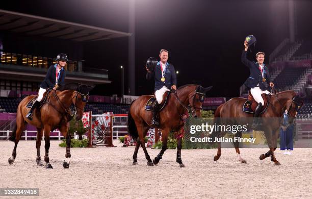 Gold medalists Malin Baryard-Johnsson, Peder Fredricson and Henrik von Eckermann of Team Sweden celebrate following the Jumping Team Final at...