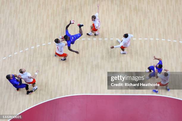 Dika Mem of Team France shoots at goal while under pressure from Magnus Landin of Team Denmark during the Men's Gold Medal handball match between...