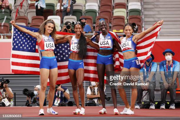 Sydney McLaughlin, Allyson Felix, Dalilah Muhammad and Athing Mu of Team United States celebrate winning the gold medal in the Women' s 4 x 400m...