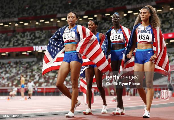 Sydney McLaughlin, Allyson Felix, Dalilah Muhammad and Athing Mu of Team United States celebrate winning the gold medal in the Women' s 4 x 400m...