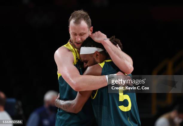 Joe Ingles of Team Australia hugs teammate Patty Mills after their win over Team Slovenia in the Men's Basketball Bronze medal game on day fifteen of...