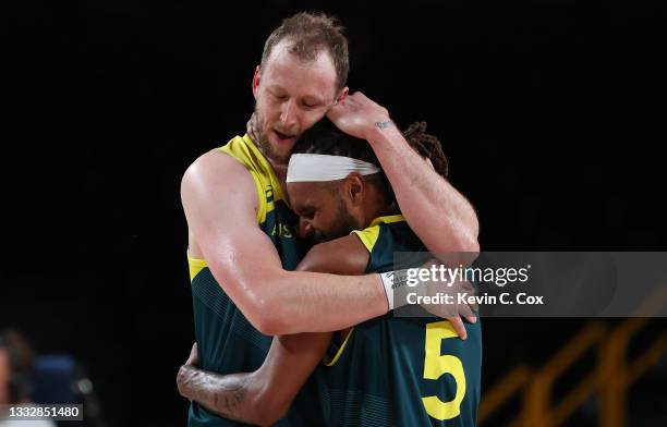 Patty Mills and Joe Ingles of Team Australia hug after their win over Slovenia in the Men's Basketball Bronze medal game on day fifteen of the Tokyo...