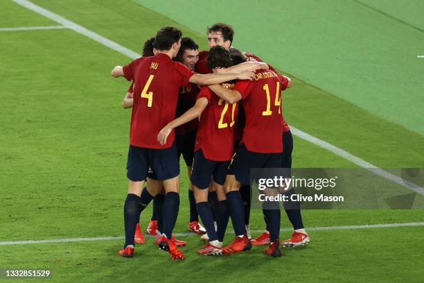 Mikel Oyarzabal of Team Spain celebrates with team mates after scoring their side's first goal during the Men's Gold Medal Match between Brazil and...