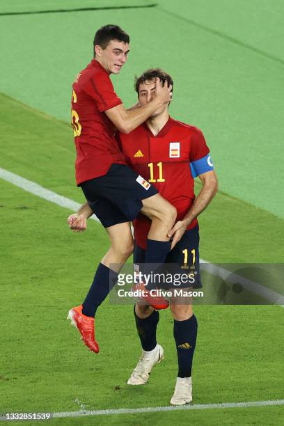 Mikel Oyarzabal of Team Spain celebrates with Pedri Gonzalez after scoring their side's first goal during the Men's Gold Medal Match between Brazil...