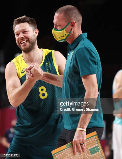 Matthew Dellavedova of Team Australia and one of his coaches celebrates a win over Slovenia in the Men's Basketball Bronze medal game on day fifteen...