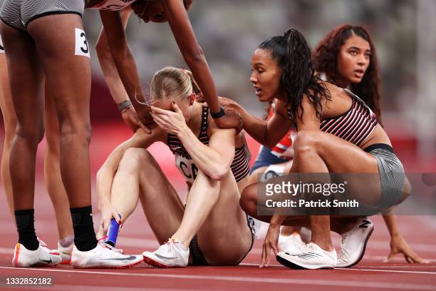 Sage Watson of Team Canada is consoled by Kyra Constantine and Alicia Brown after finishing fourth in the Women's 4 x 400 Relay Final on day fifteen...
