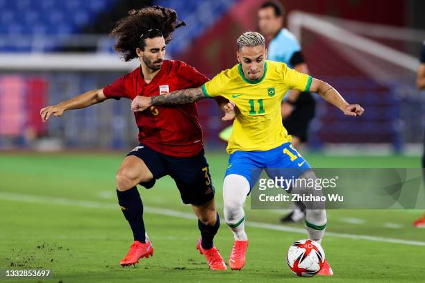 Antony of Brazil competes for the ball with Marc Cucurella of Spain during the Men's Gold Medal Match between Brazil and Spain on day fifteen of the...