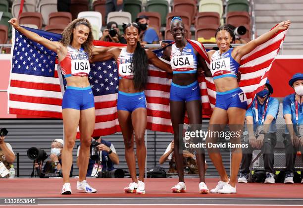 Allyson Felix, Athing Mu, Dalilah Muhammad and Sydney McLaughlin of Team United States celebrate winning the gold medal in the Women's 4 x 400m Relay...