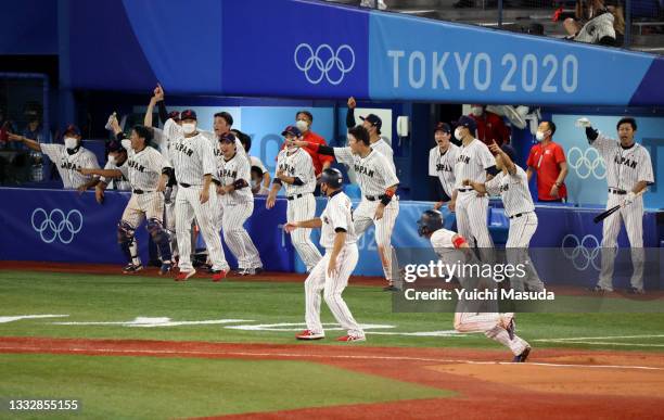 Designated hitter Tetsuto Yamada of Team dashes to the home plate to score a run by the throwing error of Outfielder Jack Lopez of Team United States...
