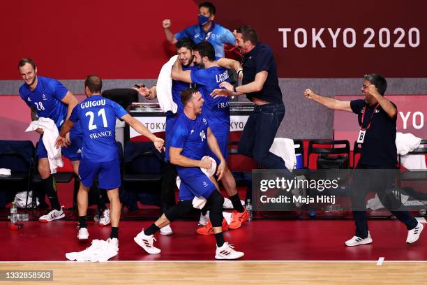 Guillaume Gille , coach of Team France celebrates with this team after defeating Team Denmark 25-23 to win the gold medal in Men's Handball on day...