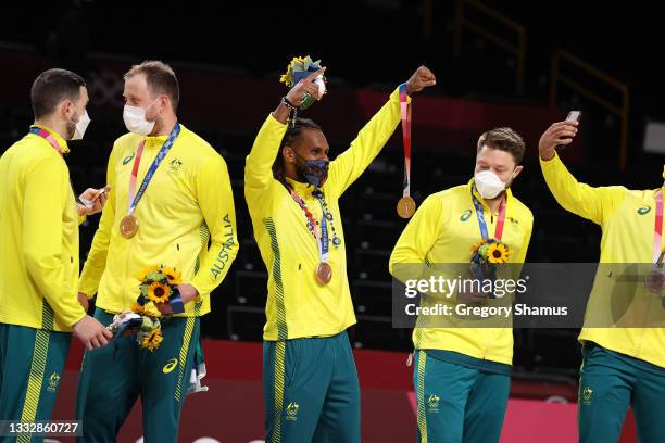 Patty Mills and his Team Australia teammates celebrate with their bronze medals during the Men's Basketball medal ceremony on day fifteen of the...