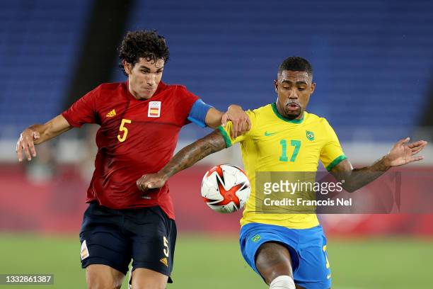 Malcom of Team Brazil battles for possession with Jesus Vallejo of Team Spain during the Men's Gold Medal Match between Brazil and Spain on day...