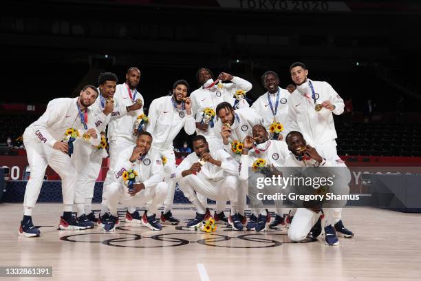 Team United States pose for photographs with their gold medals during the Men's Basketball medal ceremony on day fifteen of the Tokyo 2020 Olympic...