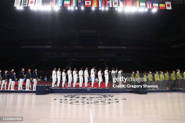 Team United States, Team France, and Team Australia stand for the American National Anthem during the Men's Basketball medal ceremony on day fifteen...