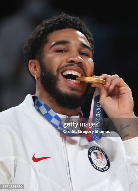 Jayson Tatum of Team United States poses for photographs with his gold medal during the Men's Basketball medal ceremony on day fifteen of the Tokyo...
