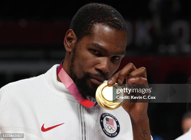 Kevin Durant of Team United States poses for photographs with his gold medal during the Men's Basketball medal ceremony on day fifteen of the Tokyo...