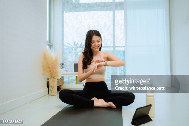 healthy woman starts her first workout at home. - gymnastic asian stockfoto's en -beelden