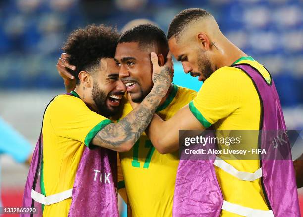 Malcom of Team Brazil celebrates with Claudinho and Matheus Cunha after scoring their side's second goal during the Men's Gold Medal Match between...