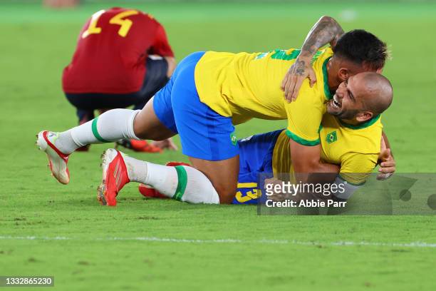 Gabriel Menino and Dani Alves of Team Brazil celebrate after defeating Team Spain 2-1 to win the men's gold medal match between Team Brazil and Team...