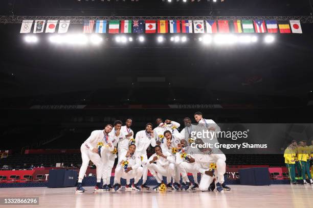 Team United States poses for photographs with their gold medals during the Men's Basketball medal ceremony on day fifteen of the Tokyo 2020 Olympic...