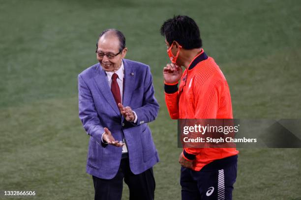 Head coach Atsunori Inaba of Team Japan is congratulated by Sadaharu Oh after winning the gold following the gold medal game between Team United...