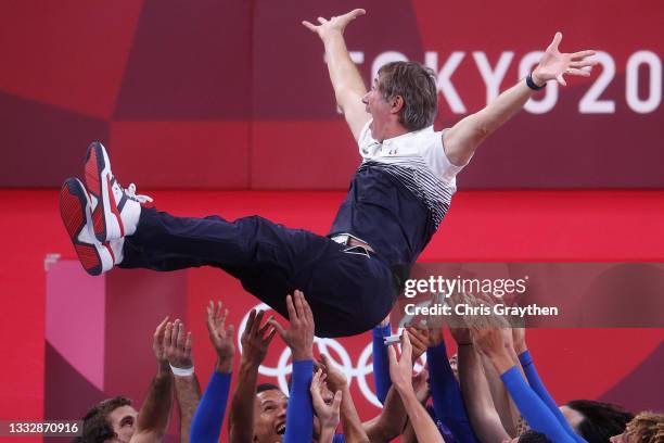 Players of Team France throw Head Coach Laurent Tillie into the air as they celebrate defeating Team ROC during the Men's Gold Medal Match on day...