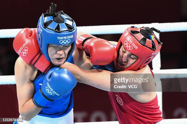 Busenaz Surmeneli of Team Turkey competes against Hong Gu of Team China during the Women's Welter Final bout on day fifteen of the Tokyo 2020 Olympic...