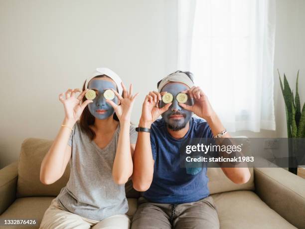 happy couple doing facial mask. - people covered in mud stock pictures, royalty-free photos & images