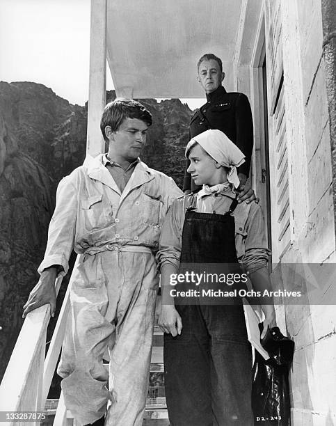 Alec Guiness watches Gerhard Hersch and Rita Tushingham leave his office in a scene from the film 'Doctor Zhivago', 1965.