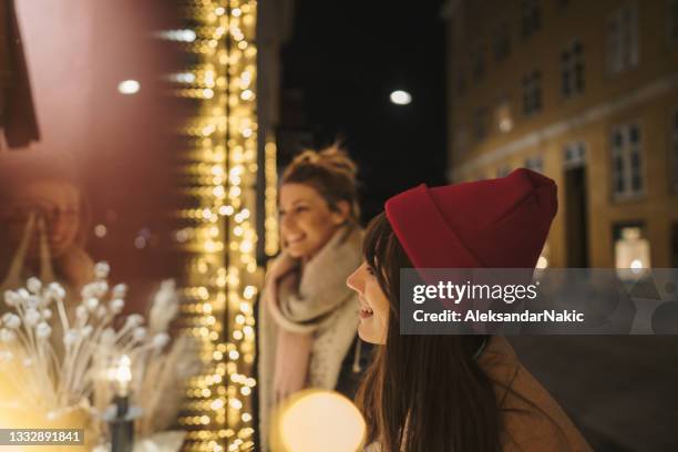 sisters looking for christmas presents - copenhagen night stock pictures, royalty-free photos & images