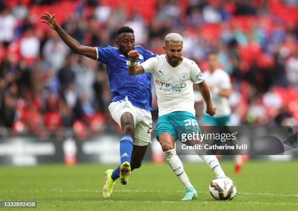 Riyad Mahrez of Manchester City shoots as he is challenged by Wilfred Ndidi of Leicester City during The FA Community Shield Final between Manchester...