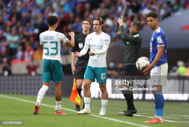 Jack Grealish of Manchester City interacts with Samuel Edozie as he replaces him during The FA Community Shield Final between Manchester City and...