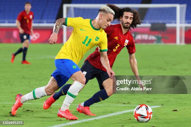 Antony of Team Brazil and Marc Cucurella of Team Spain battle for possession in the second half during the men's gold medal match between Team Brazil...