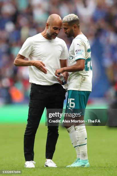 Pep Guardiola, Manager of Manchester City speaks with Riyad Mahrez of Manchester City following defeat in The FA Community Shield Final between...