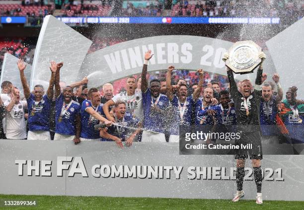 Kasper Schmeichel of Leicester City lifts The FA Community Shield as his team mates celebrate following victory in The FA Community Shield Final...