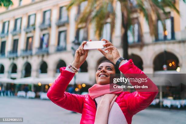 tourist woman at placa reial,barcelona taking photos - winter barcelona stock pictures, royalty-free photos & images