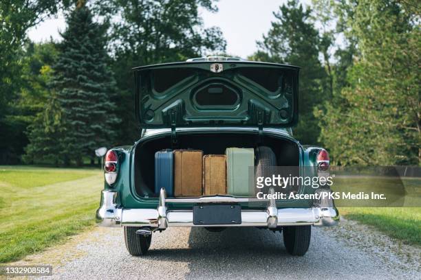 view of turquoise, vintage car parked in countryside - empty car boot stock pictures, royalty-free photos & images