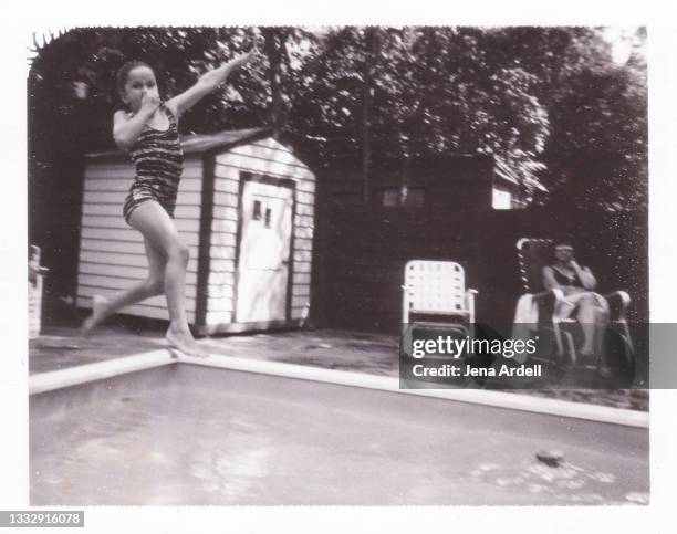 child jumping in pool vintage 1960s summer fun photograph - taking the plunge 個照片及圖片檔
