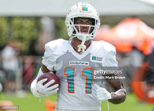 Wide Receiver DeVante Parker of the Miami Dolphins runs with the ball after making a catch in practice drills during Training Camp at Baptist Health...