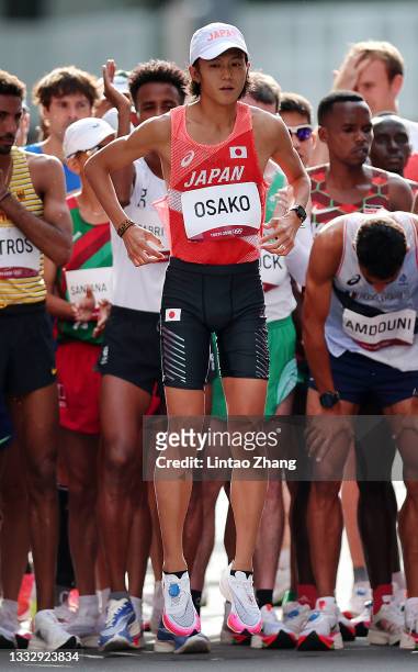 Suguru Osako of Team Japan lines up with the other athletes prior to competing in the Men's Marathon Final on day sixteen of the Tokyo 2020 Olympic...