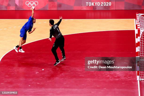 Michael Guigou of Team France shoots at goal as Niklas Landin of Team Denmark looks to save during the Men's Gold Medal handball match between France...