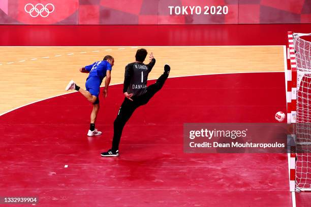 Michael Guigou of Team France shoots at goal as Niklas Landin of Team Denmark looks to save during the Men's Gold Medal handball match between France...