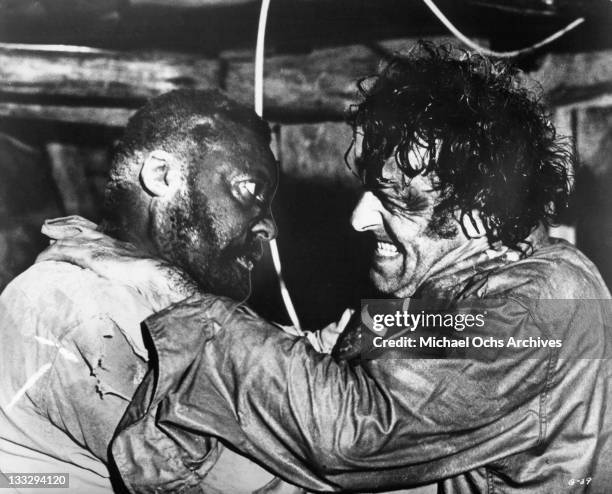 Simon Sabela tries to stop Bernard Horsfall from cutting a safety wire in a scene from the film 'Gold', 1974.